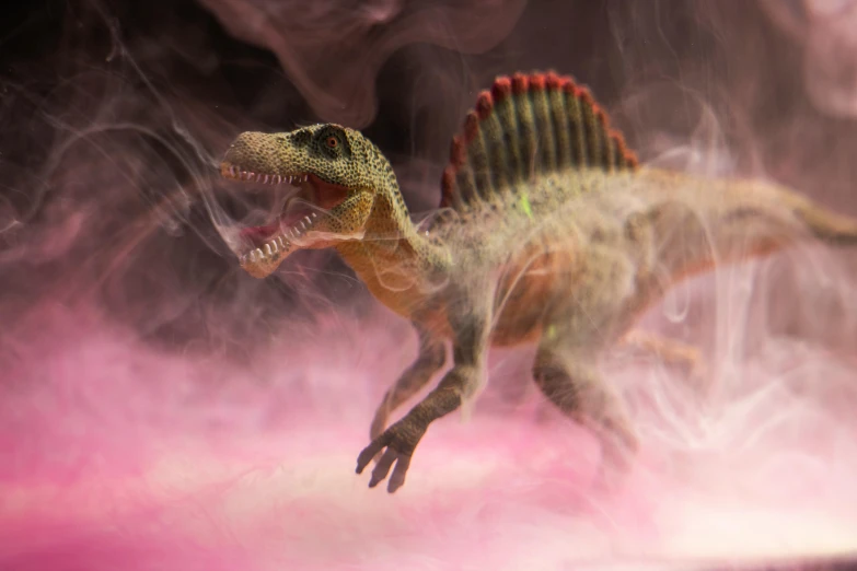 a close up of a toy dinosaur with smoke coming out of it, pexels contest winner, fantastic realism, spinosaurus, pink, diorama, national geographic photo award