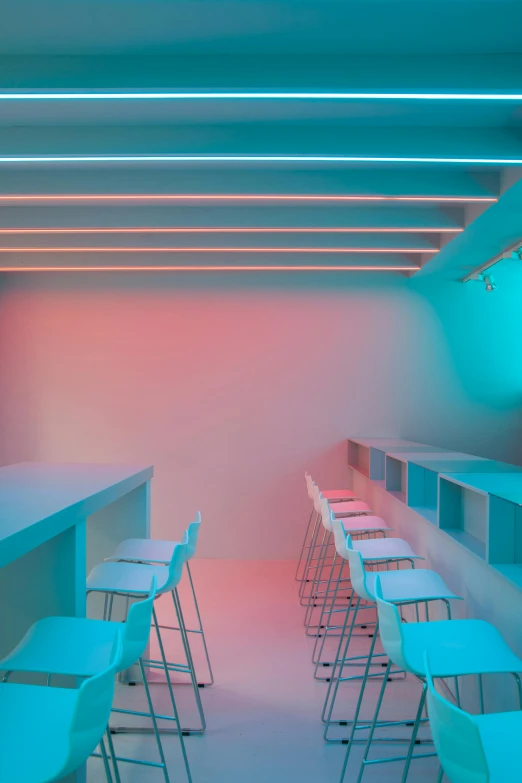 an empty bar with blue and pink lights, a digital rendering, trending on unsplash, light and space, photo of a classroom, gradient cyan, courtesy of moma, trending on dezeen