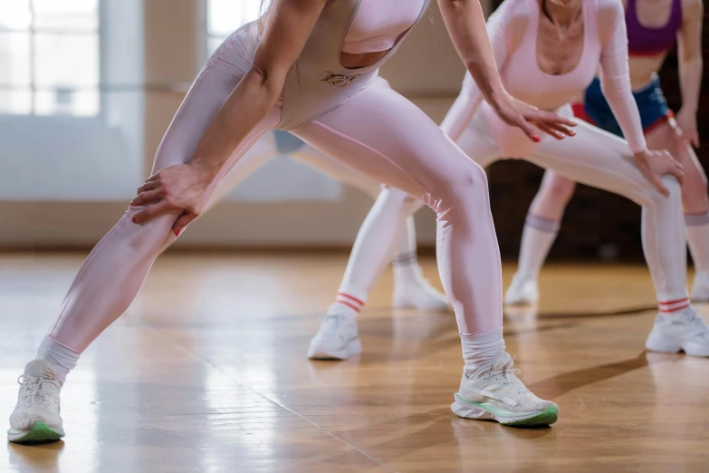 a group of women standing on top of a wooden floor, trending on pexels, arabesque, wearing white tights, dribbling, sport clothing, thumbnail