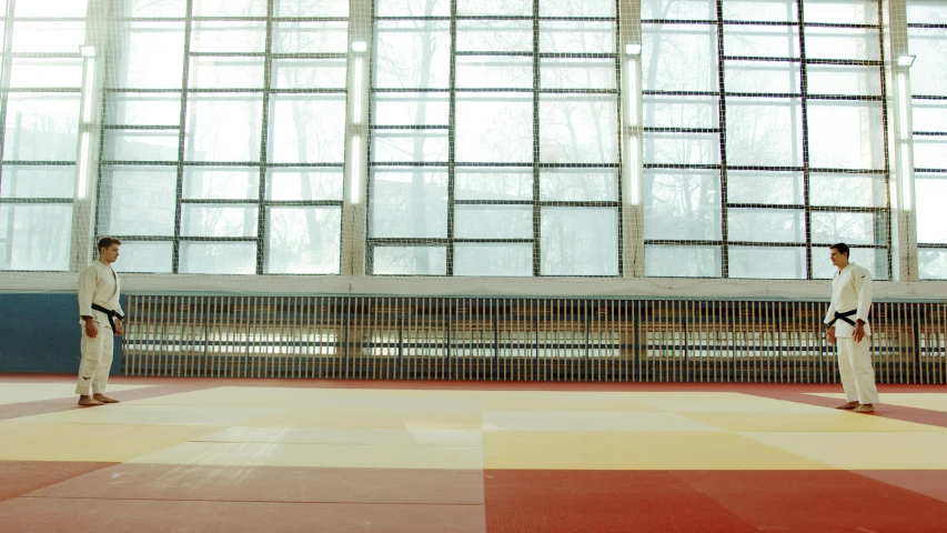 a couple of people that are standing in a room, inspired by Andreas Gursky, unsplash, shin hanga, karate, bright daylight indoor photo, local gym, seen from a distance