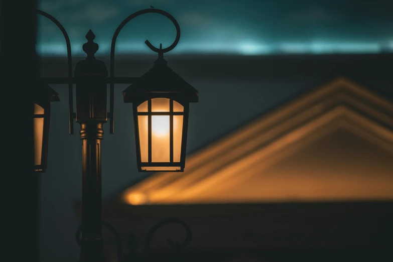 a close up of a street light with a building in the background, by Carey Morris, unsplash contest winner, realism, evening lanterns, paul barson, lanterns on the porch, lit in a dawn light