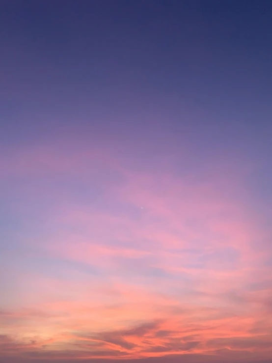 a large body of water with a sunset in the background, unsplash, postminimalism, soft blue and pink tints, taken on iphone 1 3 pro, uniform plain sky, night sky; 8k