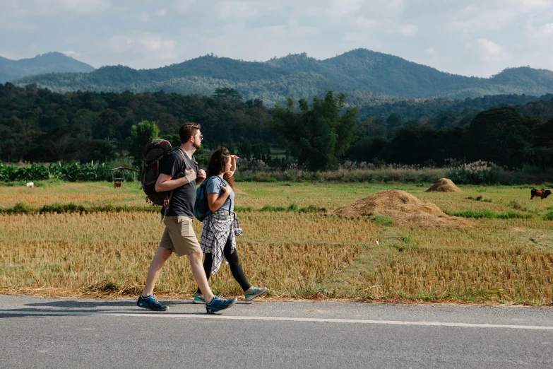 a group of people walking across a road, ruan jia and mandy jurgens, travellers, profile image, background image