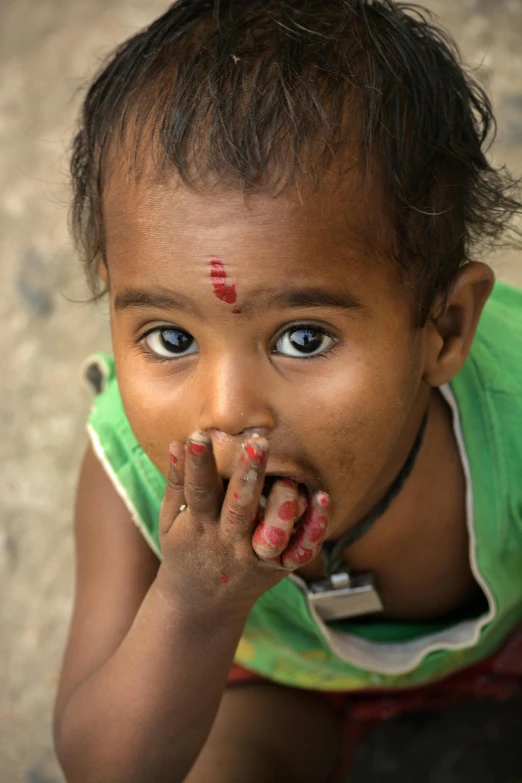 a close up of a child eating something, a picture, inspired by Steve McCurry, trending on unsplash, provocative indian, square, 4k/8k, intricate ”