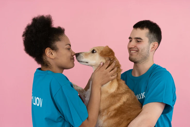 a man and woman holding a dog in front of a pink background, r / vexilology, profile image, on grey background, lesbians