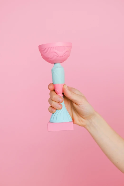 a person holding a pink and blue cup, a surrealist sculpture, inspired by Gustave Boulanger, squishy, scepter, bottom - view, award - winning