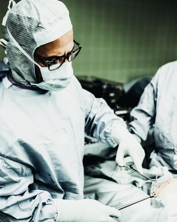 two surgeons performing surgery in an operating room, an album cover, unsplash, happening, transgender, no cropping, film photo