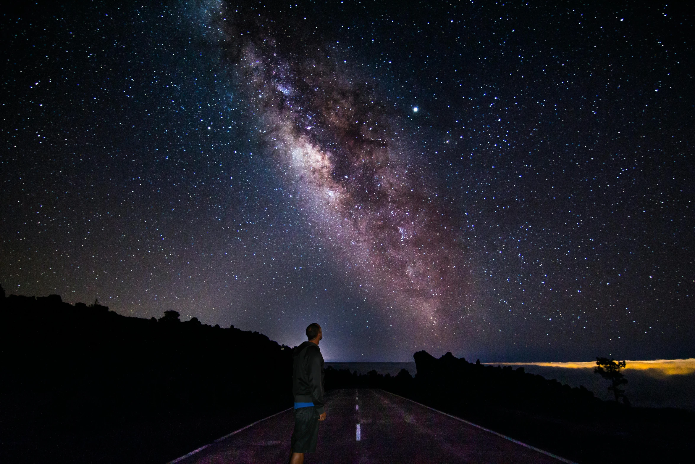 a man standing on a road with the milky in the background, unsplash contest winner, space art, huge telescope on mauna kea, 2 5 6 x 2 5 6 pixels, night sky; 8k, looking off into the distance