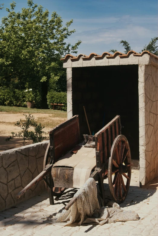 a horse pulling a cart down a dirt road, a statue, patio, toilet, ancient mediterranean village, shed