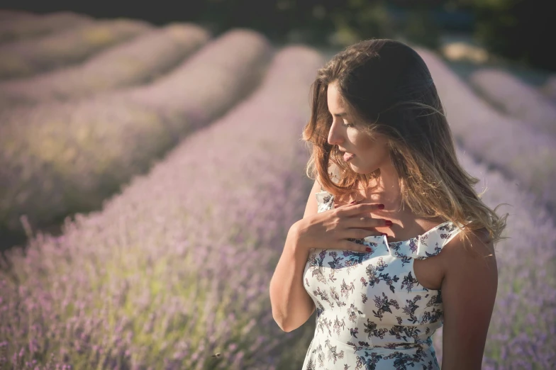 a woman standing in a field of lavender, pexels contest winner, soft shadows, fair olive skin, flirting, featured