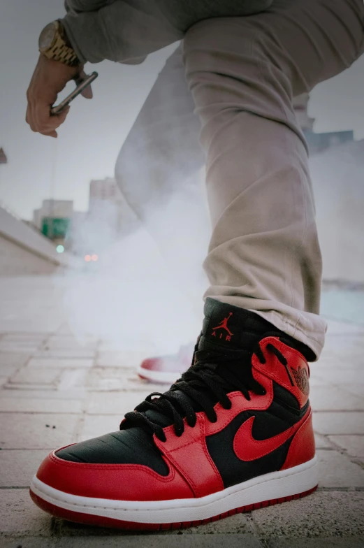 a person wearing a pair of red and black sneakers, inspired by Jordan Grimmer, trending on pexels, smoke in front, tall shot, jets, cooling