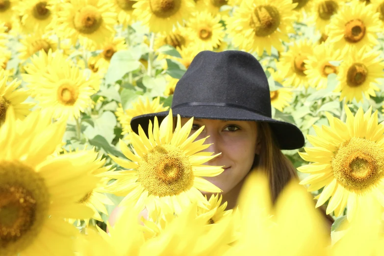 a woman wearing a hat in a field of sunflowers, a picture, avatar image, uploaded, mini model, black
