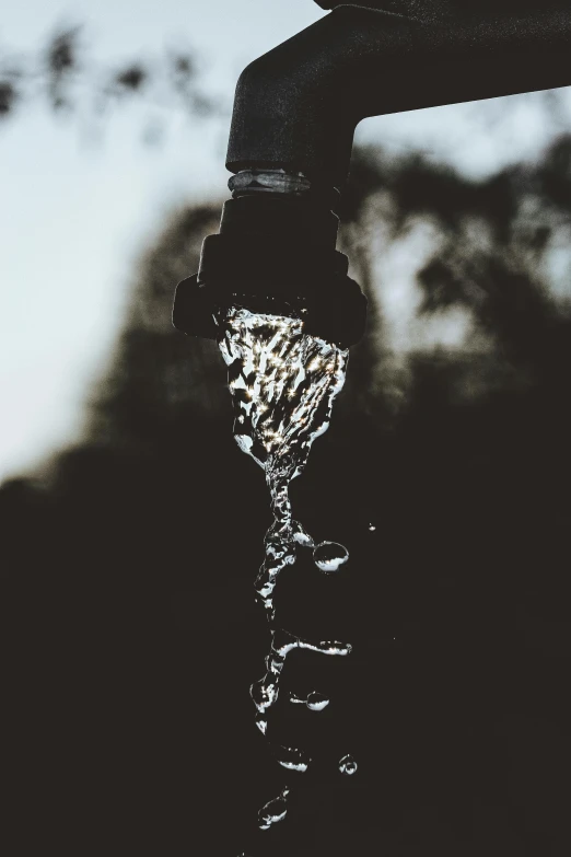 a close up of a faucet with water coming out of it, by Byron Galvez, pexels contest winner, black water, transhumanist hydration, waist high, promo image