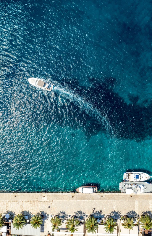 a couple of boats that are in the water, pexels contest winner, looking down from above, wall of water either side, caribbean, high resolution image