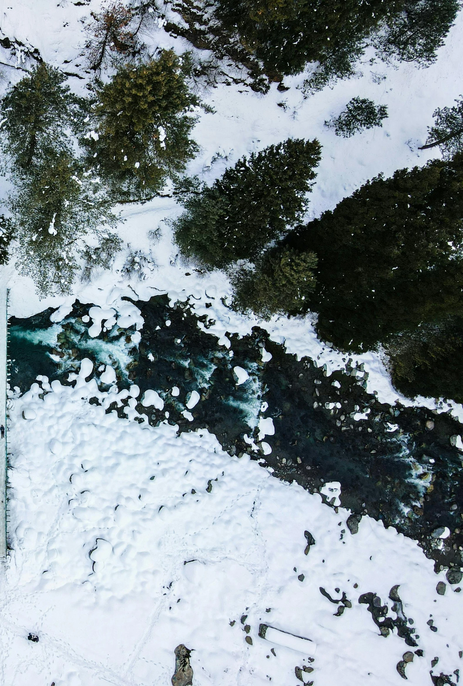 a man riding skis down a snow covered slope, an album cover, pexels contest winner, hurufiyya, river rapids, view from above, creek, high definition screenshot