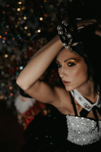 a woman posing in front of a christmas tree, a portrait, inspired by Hedi Xandt, trending on pexels, kitsch movement, steam punk party, victoria justice, woman with black hair, wearing a native american choker