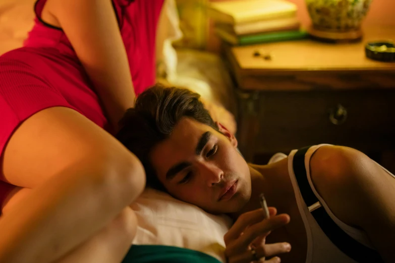 a man laying on top of a bed next to a woman, inspired by Nan Goldin, trending on pexels, happening, zayn malik, teenage boy, ! movie scene, high resolution