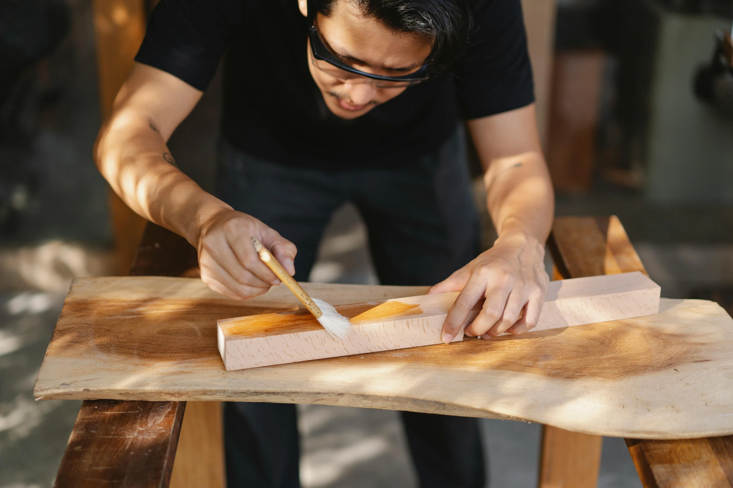 a man cutting a piece of wood with a knife, a photorealistic painting, inspired by Ogata Kōrin, pexels contest winner, curved furniture, ginko showing a new mushi, crisp smooth clean lines, an intricate