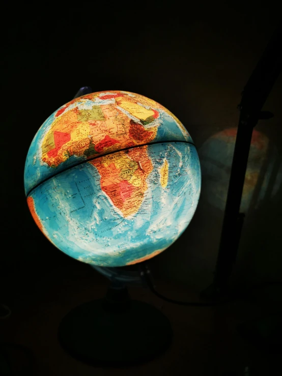 an illuminated globe sitting on top of a table, profile image, multi - coloured, close - up photograph, 2019 trending photo