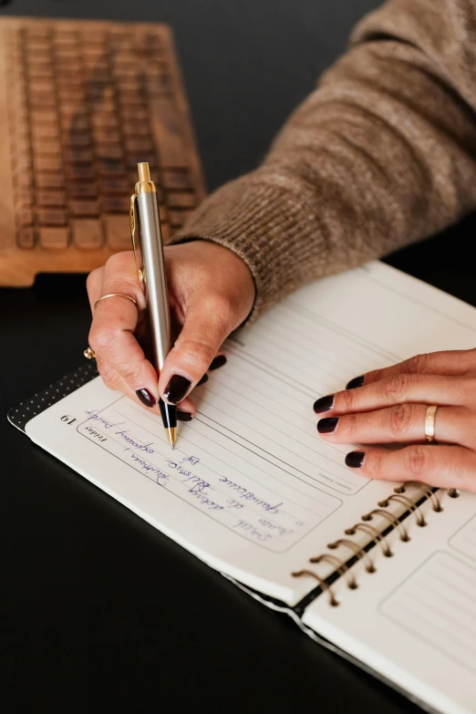 a woman writing in a notebook with a pen, curated collections, te pae, thumbnail, monthly