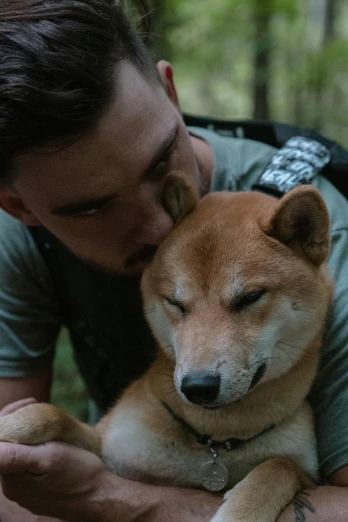 a man is hugging a dog in the woods, inspired by Shiba Kōkan, trending on unsplash, scene from live action movie, militaristic, australia, handsome face