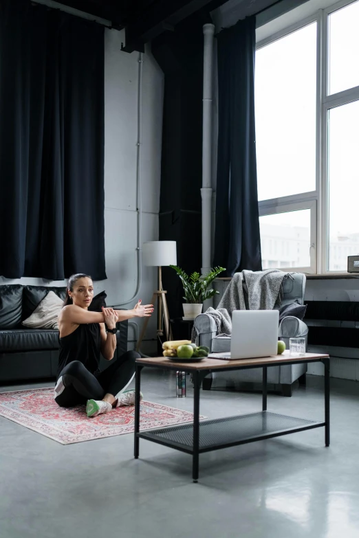 a woman sitting on a couch in a living room, pexels contest winner, hypermodernism, standing athletic pose, rugs, working out, empty room with black walls