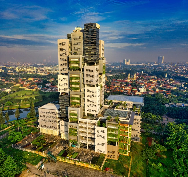 a tall building sitting on top of a lush green hillside, an album cover, by Basuki Abdullah, pexels contest winner, photorealism, highrise business district, panoramic view, archviz, research complex