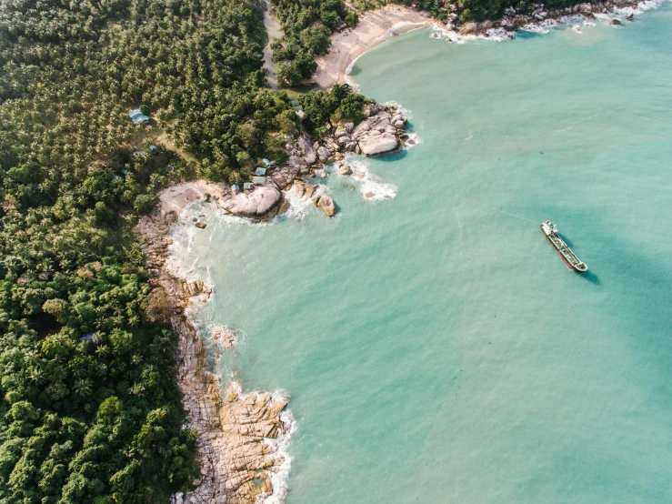 a boat in the middle of a large body of water, pexels contest winner, beach and tropical vegetation, helicopter view, thawan duchanee, sparkling cove