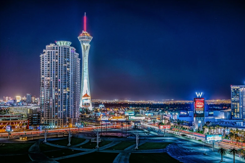 the city skyline is lit up at night, by Ryan Pancoast, unsplash contest winner, art nouveau, sin city, 4 k photography hdr, square, googie architecture