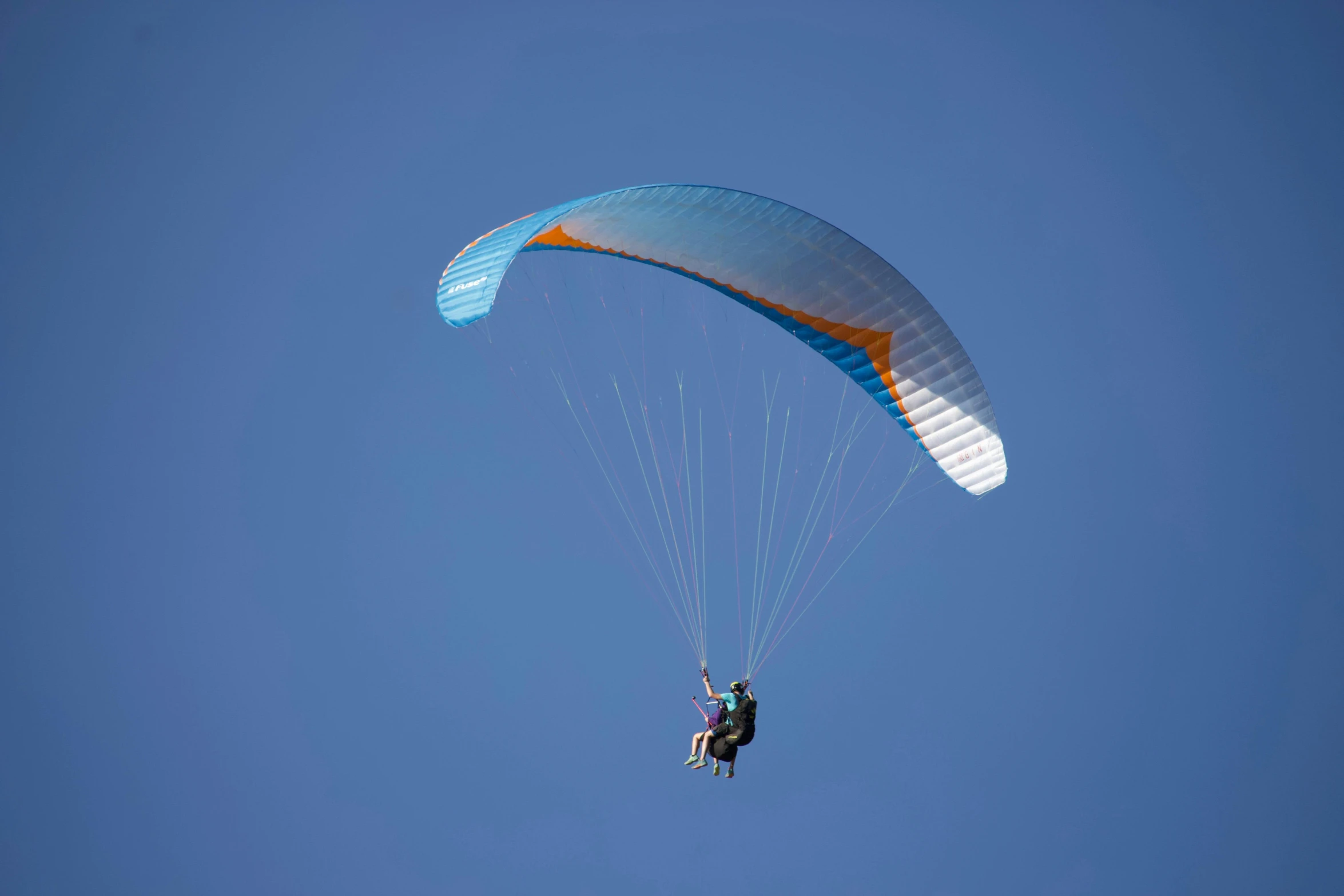 a person that is in the air with a parachute, by Eglon van der Neer, hurufiyya, clear blue skies, picton blue, profile shot, back lit