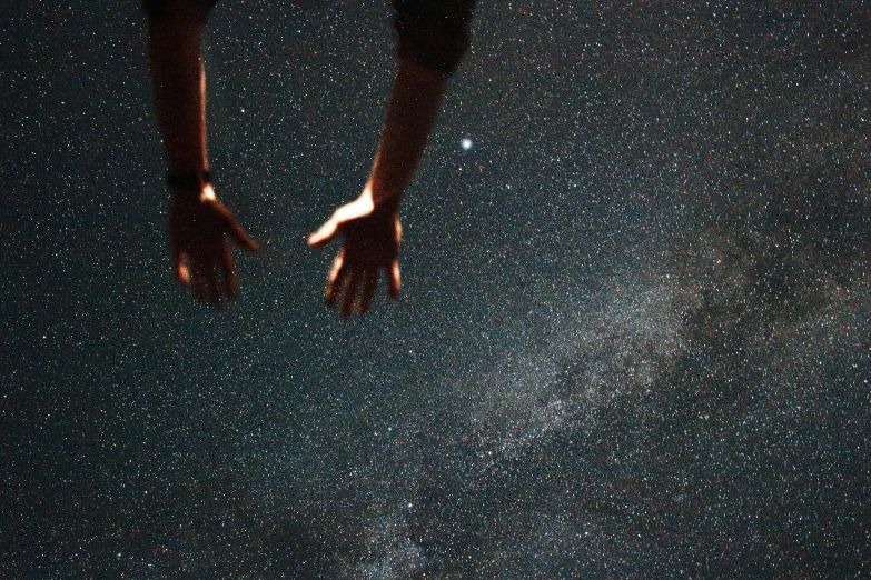 a person reaching for the stars in the sky, pexels contest winner, light and space, shrugging arms, grainy, swimming in space, reaching out to each other