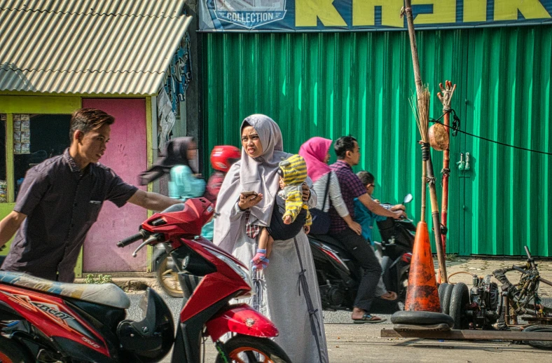 a couple of people that are standing in the street, by Ibrahim Kodra, pexels contest winner, realism, moped, malaysian, woman holding another woman, square