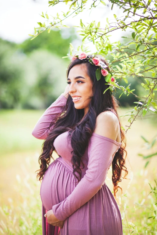 a pregnant woman wearing a purple dress in a field, pexels contest winner, wearing a pink head band, young woman with long dark hair, wearing a laurel wreath, olive skin color
