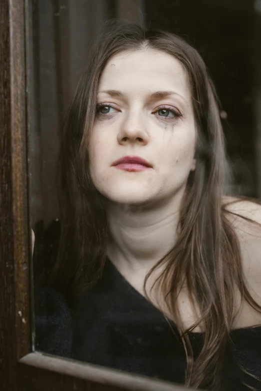 a close up of a person looking out a window, inspired by Anna Füssli, renaissance, with a bruised face and bruises, morgana, leaning on door, modelling