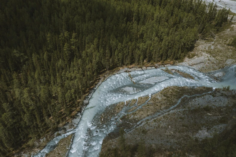 an aerial view of a river running through a forest, by Jacob Toorenvliet, pexels contest winner, hurufiyya, icy glaciers, grey, thumbnail, high quality image