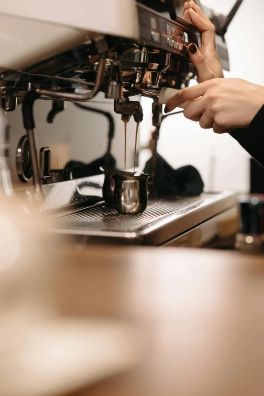 a close up of a person using a coffee machine