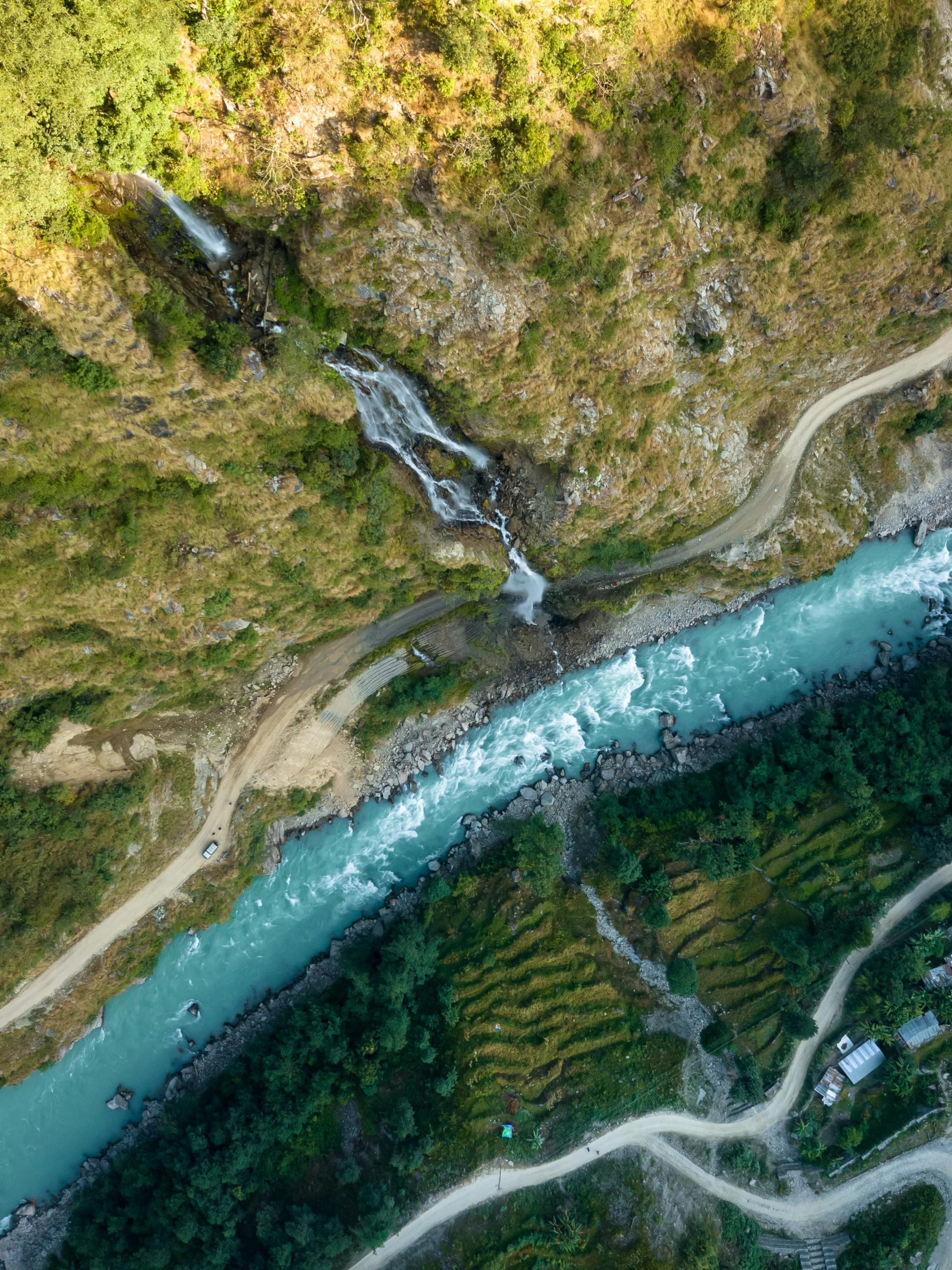 a river running through a lush green forest, by Daren Bader, pexels contest winner, hurufiyya, helicopter view, nepal, landslide road, thumbnail