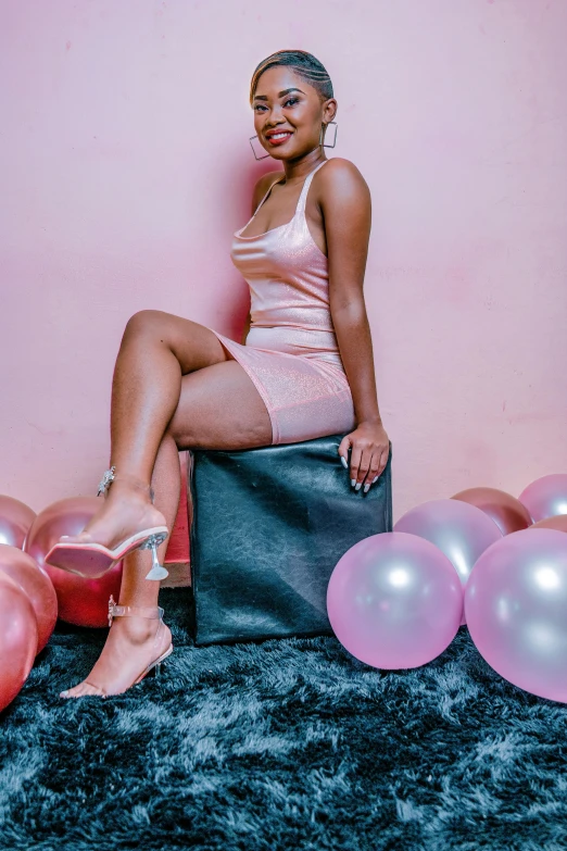 a woman sitting on top of a pile of balloons, pink 7 inch high heels, portrait photo of a backdrop, ( ( dark skin ) ), thicc