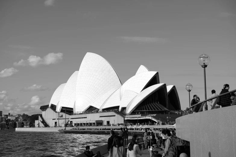 a black and white photo of the sydney opera house, a black and white photo, pexels contest winner, hurufiyya, tourists in background, july 2 0 1 1, viewed from the harbor, architecture photo