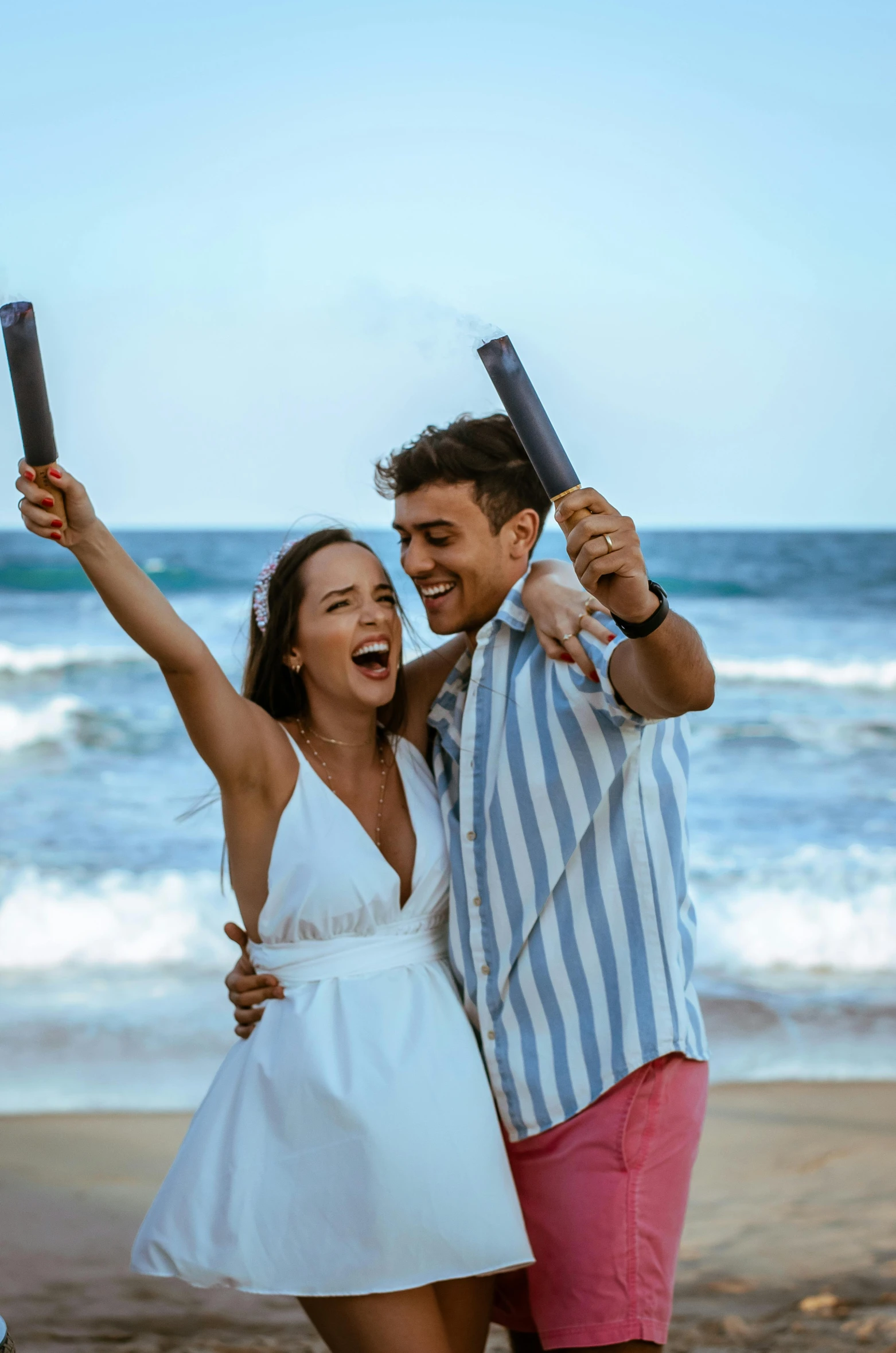 a man and woman taking a selfie on the beach, happening, smokey cannons, post graduate, smiling playfully, manly