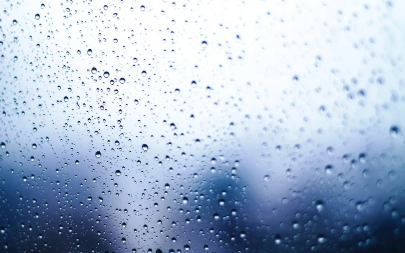 a close up of water droplets on a window, an album cover, pexels, shades of blue and grey, background image, thirst, a hyper realistic