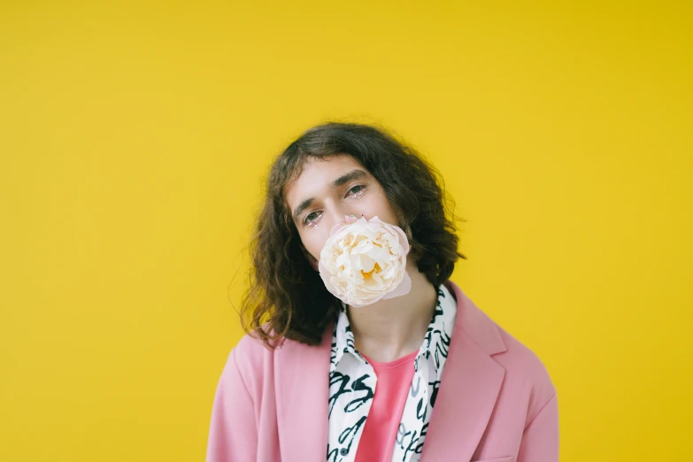 a man with a donut in his mouth, an album cover, by Winona Nelson, trending on pexels, wearing yellow floral blouse, robert sheehan, toiletpaper magazine, youtube thumbnail