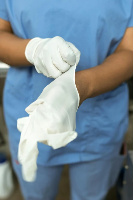 a person in a blue shirt and white gloves, white lab coat, thumbnail, surgical supplies, wear and tear