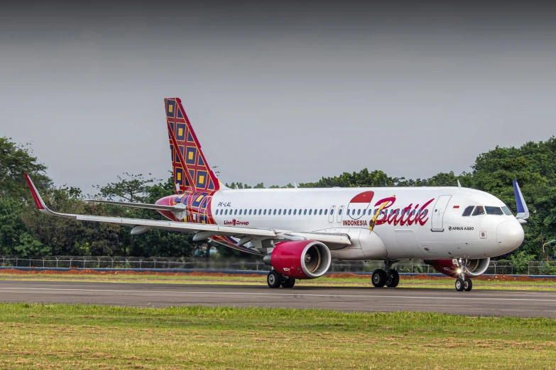 a large jetliner sitting on top of an airport runway, by Dicky Doyle, pexels contest winner, graffiti, pink and red color scheme, bali, barbie, panorama shot