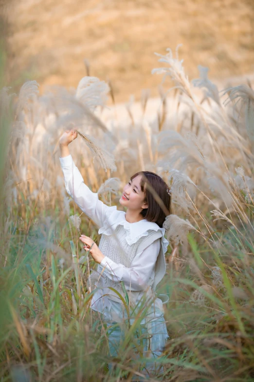 a woman flying a kite in a field of tall grass, a picture, by Yang J, medium portrait soft light, 🍁 cute, cotton, product introduction photo