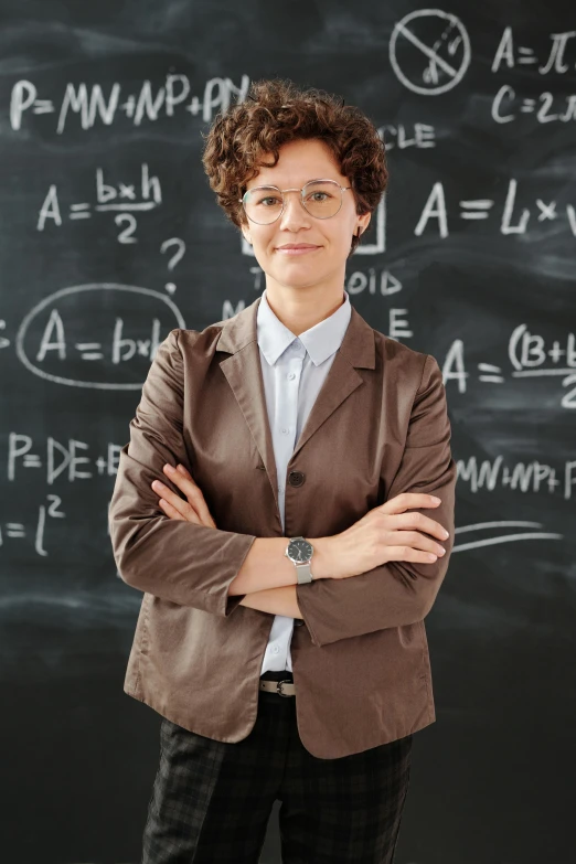 a woman standing in front of a blackboard, by Matthias Stom, shutterstock, wearing a suit and glasses, asher duran, engineer, brown ) )