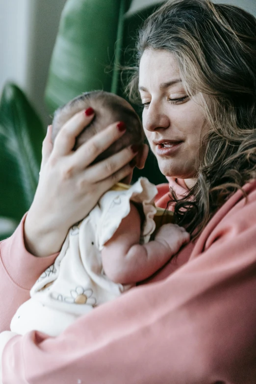 a woman holding a baby in her arms, pexels, jen atkin, overlooking, creating a soft, wētā fx