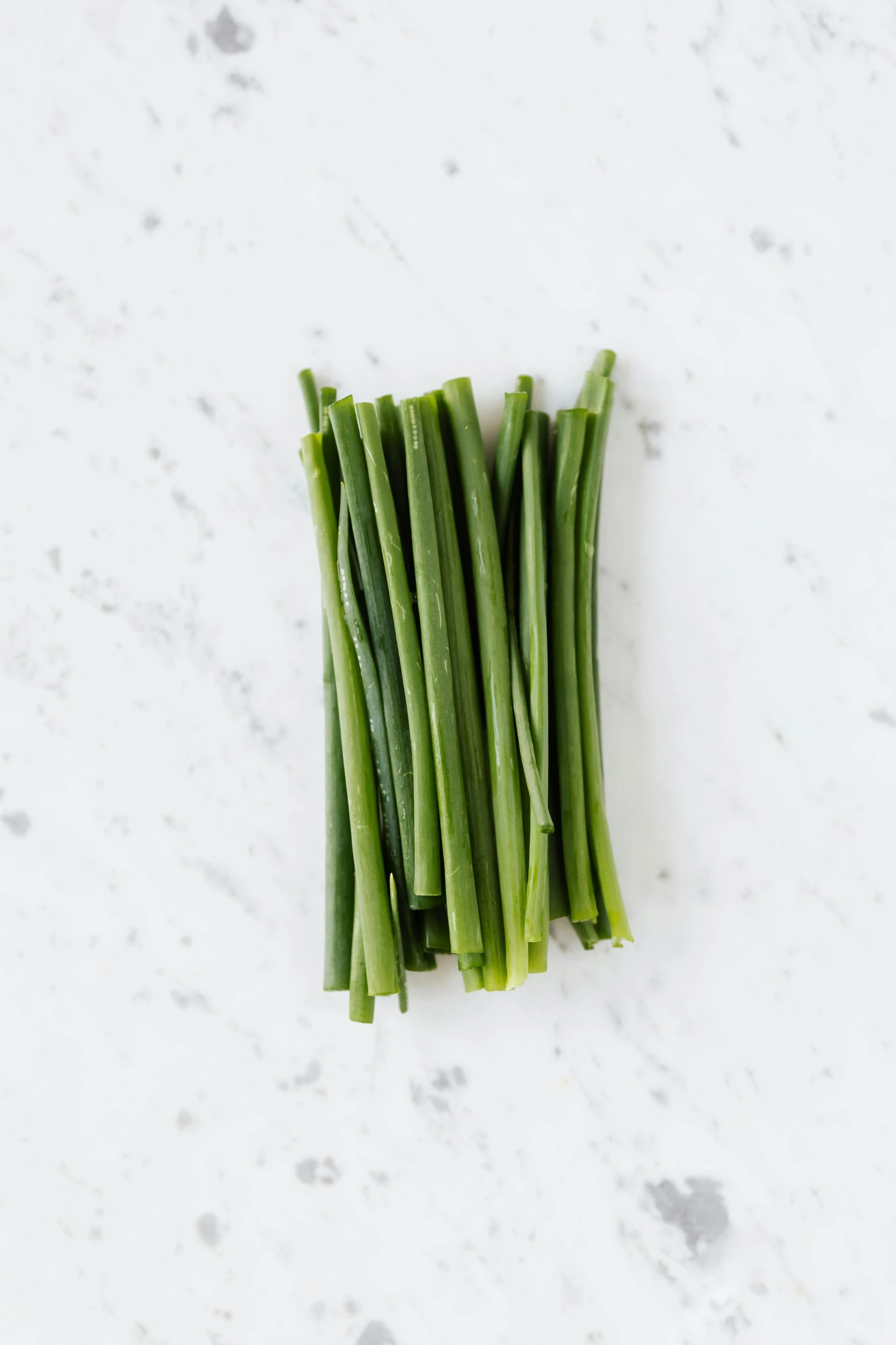 a bunch of green onions sitting on top of a counter, detailed product image, beans, slightly tanned, sleek white