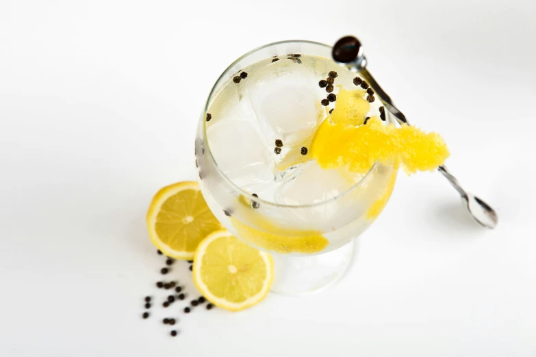 a glass filled with lemon and black pepper sprinkles, renaissance, vodka, white and yellow scheme, tamborine, thumbnail