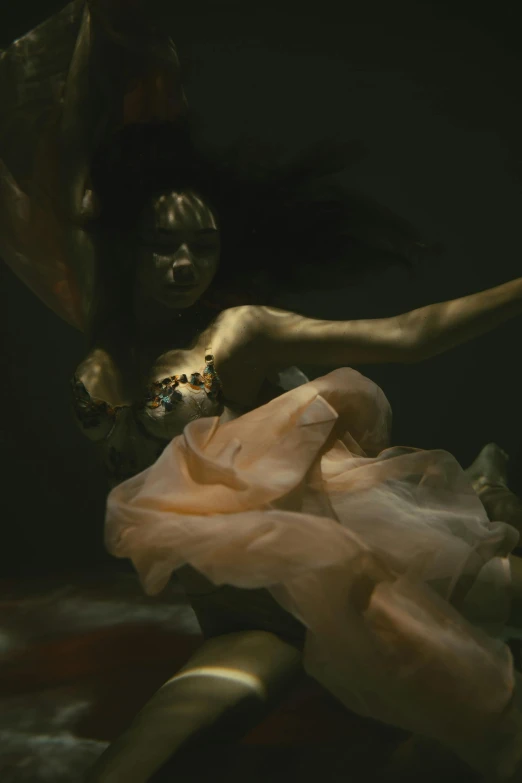 a woman in a pink dress is under water, an album cover, unsplash contest winner, draped in silky gold, roberto ferri and ruan jia, detail shot, nadav kander